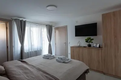 a bedroom with a bed with two towels on it at Kolonja Apartmani in Arandjelovac