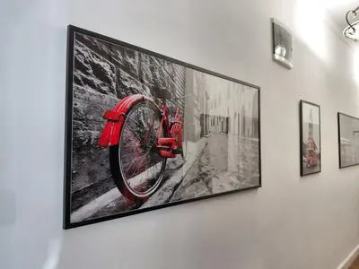 a framed picture of a red bike on a wall at World Traveler in Belgrade