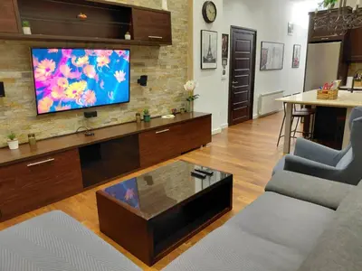 a living room with a flat screen tv on a wall at World Traveler in Belgrade