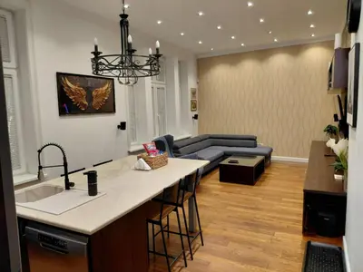 a kitchen and a living room with a couch at World Traveler in Belgrade