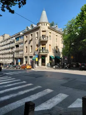 a building on a street with a crosswalk at World Traveler in Belgrade