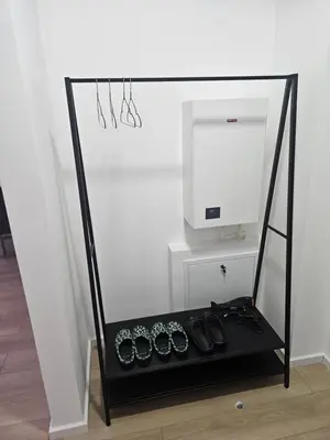 a stand with a tv and watches in a room at Miss LUX in Mladenovac