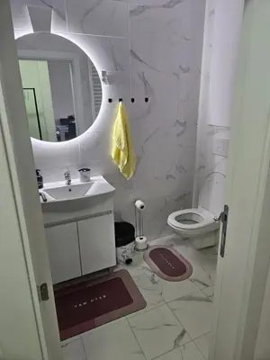 a bathroom with a sink and a toilet and a mirror at Miss LUX in Mladenovac