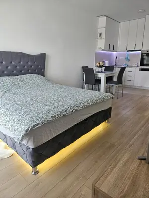 a bedroom with a bed and a table with chairs at Miss LUX in Mladenovac