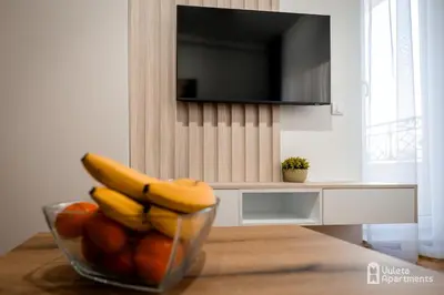 a bowl of bananas and oranges on a table at Vuleta Apartments Aranđelovac in Arandjelovac