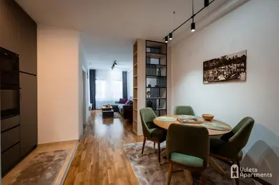 a living room with a dining room table and chairs at Vuleta Apartments Aranđelovac in Arandjelovac