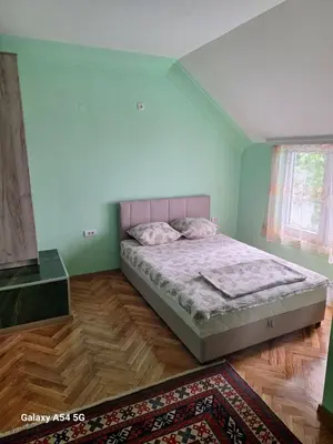 a bedroom with a bed in a room with a rug at Dream 9 in Belgrade