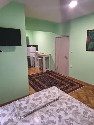 a room with a bed and a table and a television at Dream 9 in Belgrade