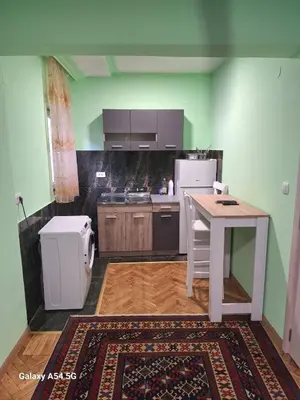 a kitchen with a table and a refrigerator at Dream 9 in Belgrade