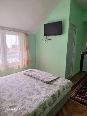 a bedroom with a bed and a flat screen tv at Dream 9 in Belgrade