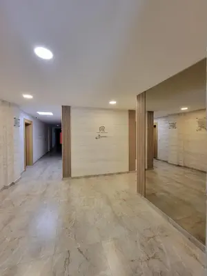 a large empty room with wooden walls and tile floors at Park Residence Apartman 1, Mirijevo, Beograd in Belgrade