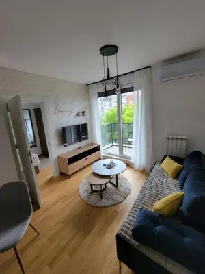 a living room with a couch and a table at Park Residence Apartman 1, Mirijevo, Beograd in Belgrade