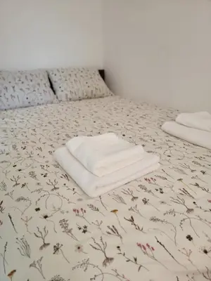 a bed with two white towels on top of it at Park Residence Apartman 1, Mirijevo, Beograd in Belgrade