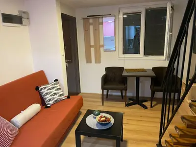 a living room with a couch and a table at Central duplex apartment in Belgrade