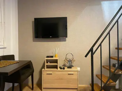 a living room with a television on a wall at Central duplex apartment in Belgrade