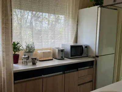 a kitchen with a counter with a microwave and a window at R&R Apartmant Konjarnik in Belgrade