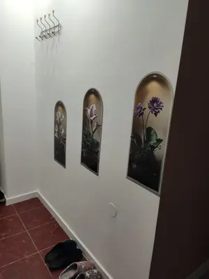 a wall with three pictures of flowers on it at KS Studio 2 in Belgrade