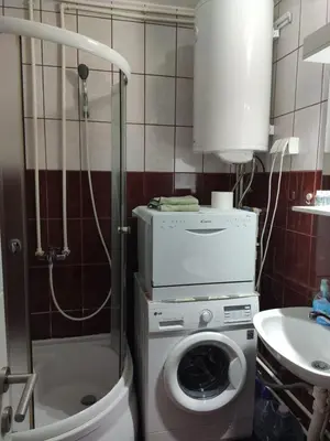 a bathroom with a washing machine and a sink at KS Studio 2 in Belgrade