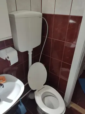 a bathroom with a white toilet and a sink at KS Studio 2 in Belgrade
