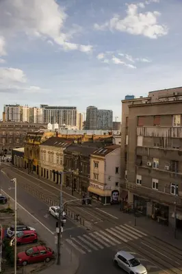 a city with cars parked on a street with buildings at Adagio 7 in Belgrade