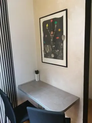 a table in a room with a picture on the wall at Adagio 7 in Belgrade