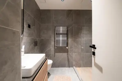 a bathroom with a shower and a toilet and a sink at BW Simfonija 1 in Belgrade