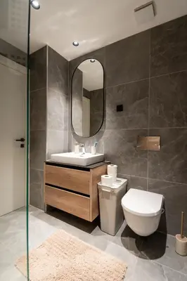 a bathroom with a toilet and a sink and a mirror at BW Simfonija 1 in Belgrade