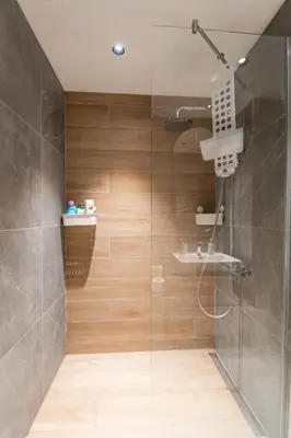 a bathroom with a shower with a glass door at BW Simfonija 1 in Belgrade