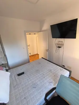 a bedroom with a bed and a flat screen tv at Apartment for a day, Zemun, Altina, two rooms in Belgrade
