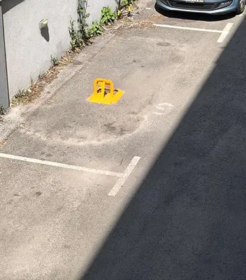 a yellow object in a parking lot next to a car at Apartment for a day, Zemun, Altina, two rooms in Belgrade