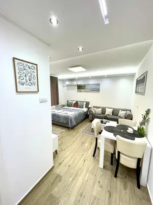 a living room with a couch and a table at Perla Suite Vracar in Belgrade