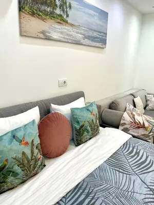 a bed with pillows on it in a bedroom at Perla Suite Vracar in Belgrade