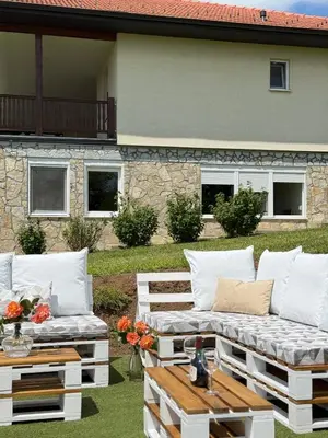a patio with white couches and a table at Zen Cherry House- Vikendica na dan sa bazenom1,5ha izmedju Avale i Kosmaja in Drobnjaci