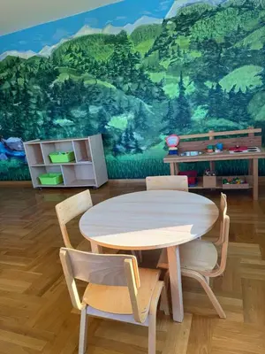 a dining room with a table and chairs and a mural at Zen Cherry House- Vikendica na dan sa bazenom1,5ha izmedju Avale i Kosmaja in Drobnjaci