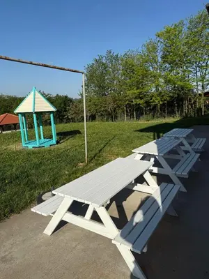 a picnic table and a gazebo in a park at Zen Cherry House- Vikendica na dan sa bazenom1,5ha izmedju Avale i Kosmaja in Drobnjaci