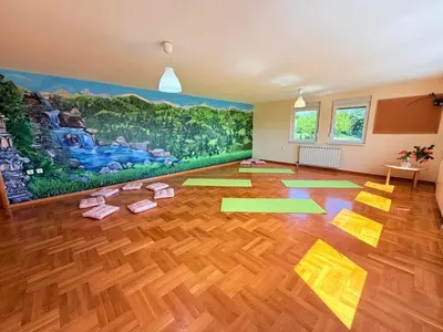 a room with yoga mats on the floor in front of a mural at Zen Cherry House- Vikendica na dan sa bazenom1,5ha izmedju Avale i Kosmaja in Drobnjaci