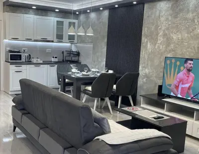 a living room with a couch and a kitchen at Apartman Manda in Belgrade