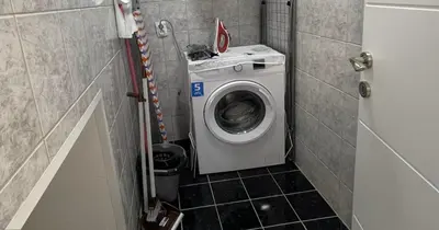 a small bathroom with a washing machine in a stall at Apartman Manda in Belgrade