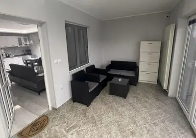 a living room with two chairs and a table at Apartman Manda in Belgrade