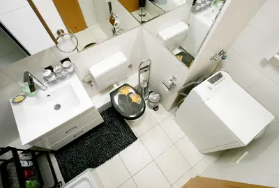 a white bathroom with a sink and a toilet at Apartment Purple in Belgrade