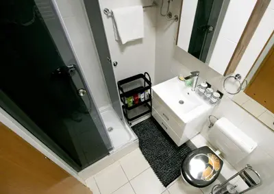 a bathroom with a toilet and a sink and a shower at Apartment Purple in Belgrade