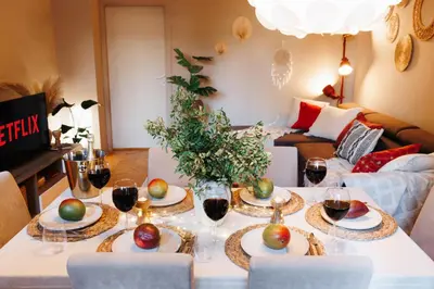 a table with glasses of wine and apples on it at Bright Harmony with Balcony Old Town Renovated in Belgrade
