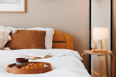a bed with a bowl of food and a book on it at Bright Harmony with Balcony Old Town Renovated in Belgrade