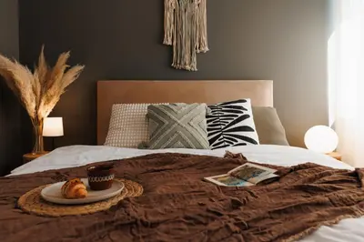 a bed with a tray with a plate of food on it at Bright Harmony with Balcony Old Town Renovated in Belgrade
