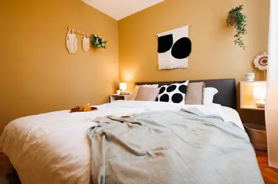 a bedroom with a large bed with black and white pillows at Bright Harmony with Balcony Old Town Renovated in Belgrade