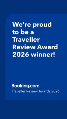 a blue sign that says were proud to be a traveller reviewagency winner at Design Suite in Prime Location Superstring Home in Belgrade