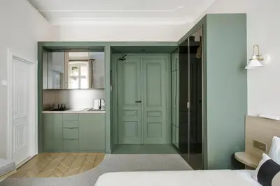 a bedroom with a door leading into a bathroom at Design Suite in Prime Location Superstring Home in Belgrade