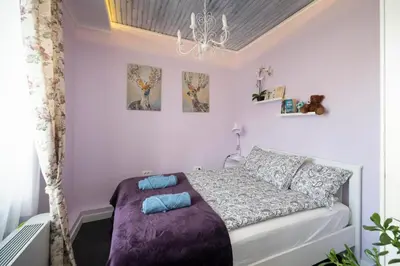 a bedroom with a bed with blue pillows on it at The Belfort Townhomes - Lux Salon in Belgrade