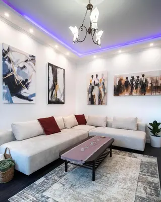 a living room with a white couch and a table at The Belfort Townhomes - Lux Salon in Belgrade