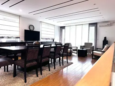 a large room with a dining table and chairs at Triplex with garden and parking in Belgrade